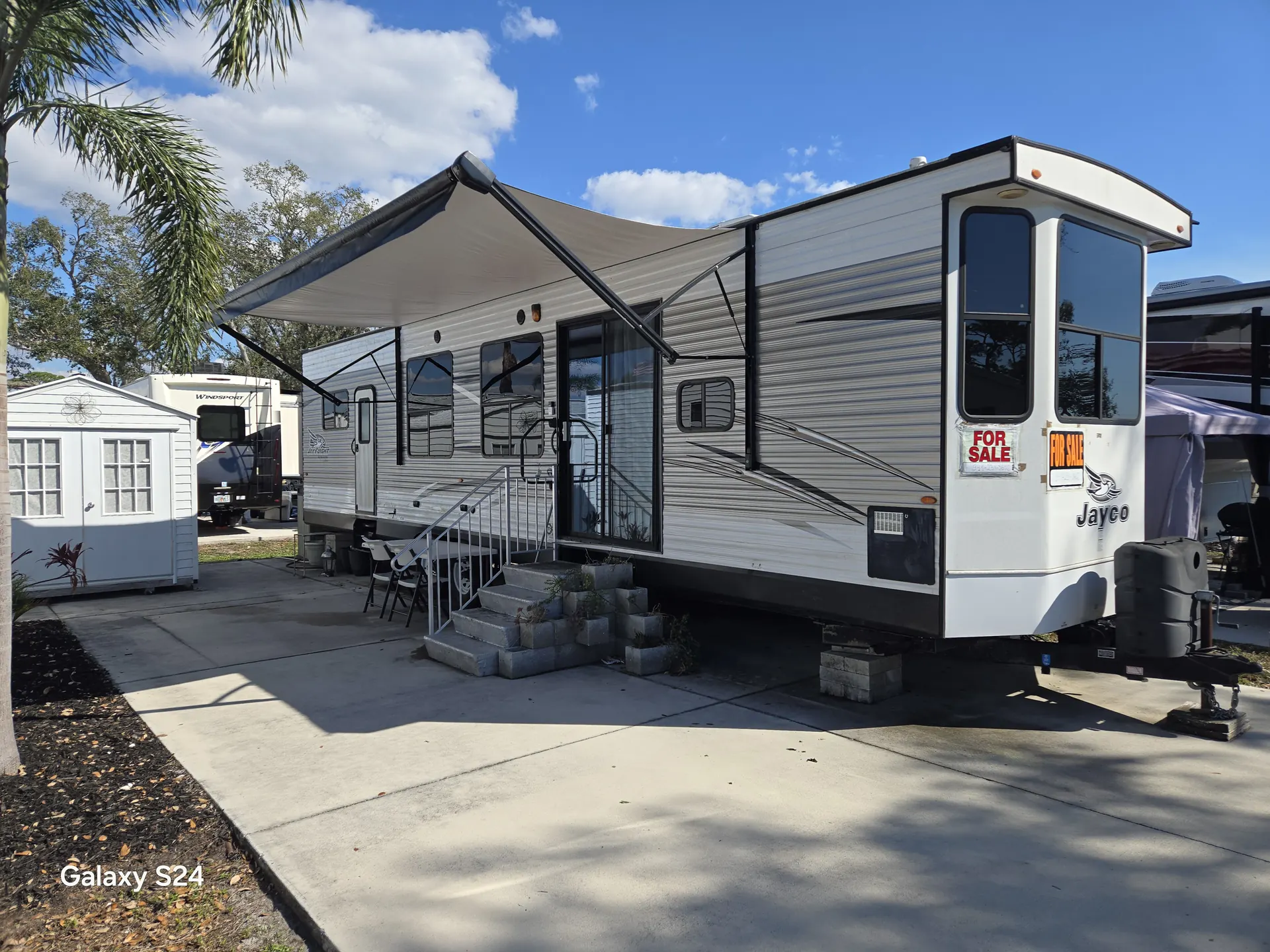 Jayco destination trailer with repaired patio awning extended in Bradenton, Florida